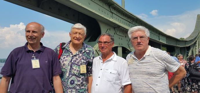 Four smiling BHA members on the Glienicke Bridge on a summer tour